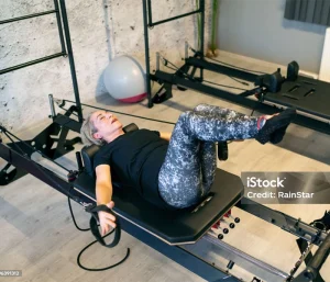 menopause-woman-doing-pilates-reformer